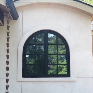 Wrought Double Iron Doors Featuring Arched Top Glass 